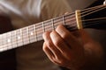 Acoustic guitar fingerboard detail and fingers doing a chord Royalty Free Stock Photo