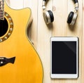 Acoustic Guitar with headphone and tablet for music Royalty Free Stock Photo