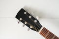 Acoustic guitar headstock and fretboard on grey background Royalty Free Stock Photo