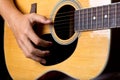 Acoustic guitar man`s hand strumming guitar chords close up photo