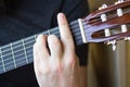 Acoustic guitar neck with body and strings in hand, close-up Royalty Free Stock Photo