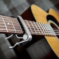 Acoustic guitar neck with a capo Royalty Free Stock Photo