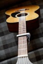 Acoustic guitar neck with a capo Royalty Free Stock Photo