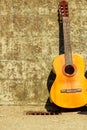 Acoustic guitar outdoor on wall background Royalty Free Stock Photo