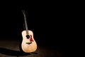 Acoustic guitar over dark background with copy space Royalty Free Stock Photo