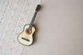 The acoustic guitar on a paper ornament background