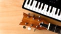 Acoustic guitar and piano keys on a wooden background Royalty Free Stock Photo