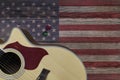 Acoustic Guitar Placed On An Old Wooden Table, With A Picture Of An American Flag On Wood