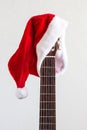 acoustic guitar with red Santa hat. Christmas song music concept on white background Royalty Free Stock Photo