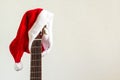 acoustic guitar with red Santa hat. Christmas song music concept on white background Royalty Free Stock Photo