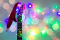 acoustic guitar with red Santa hat and light colorful garland. Christmas music concept Royalty Free Stock Photo