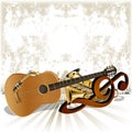 Acoustic guitar rests on the treble clef trumpet Royalty Free Stock Photo