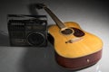 Acoustic guitar with retro radio player. Royalty Free Stock Photo