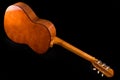 Acoustic guitar from the reverse side on a black background