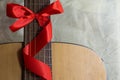 Acoustic guitar with a ribbon bow Royalty Free Stock Photo