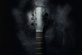 An acoustic guitar stands against the wall against a dark background. Background Royalty Free Stock Photo
