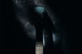 An acoustic guitar stands against the wall against a dark background. Background Royalty Free Stock Photo