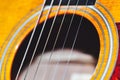 Acoustic guitar strings over the hole Royalty Free Stock Photo