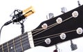 Acoustic Guitar Tuners with Gold Condenser Microphone in Background Royalty Free Stock Photo