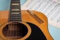 Acoustic guitar tuning fork and music sheets Royalty Free Stock Photo