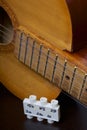 Acoustic guitar and tuning fork to adjust it. On a dark background. Royalty Free Stock Photo