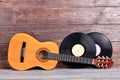 Acoustic guitar and vinyl records.