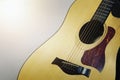 Acoustic guitar, wood pattern, placed against the wall of the room Royalty Free Stock Photo