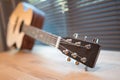 Acoustic guitar on wooden table in the room,Travel accessories concept Royalty Free Stock Photo