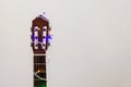 Acoustic guitar wrapped by colorful garland. christmas and new year music gift Royalty Free Stock Photo