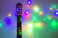 Acoustic guitar wrapped by colorful garland. christmas and new year music gift Royalty Free Stock Photo