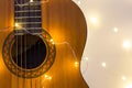 acoustic guitar wrapped in a luminous garland. Christmas gift