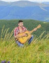 Acoustic music. Man with guitar on top of mountain. Summer music festival outdoors. Playing music. Sound of freedom Royalty Free Stock Photo