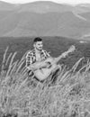 Acoustic music. Man with guitar on top of mountain. Summer music festival outdoors. Playing music. Sound of freedom Royalty Free Stock Photo