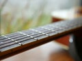 Acoustic wood guitar close up on wooden background with fretboard, strings, and tuners for music blogs, musician social media. Royalty Free Stock Photo