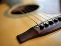 Acoustic wood guitar close up on wooden background with fretboard, strings, and tuners for music blogs, musician social media. Royalty Free Stock Photo