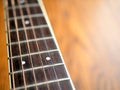 Acoustic wood guitar close up on wooden background with fretboard, strings, and tuners for music blogs, musician social media. Royalty Free Stock Photo