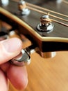 Acoustic wood guitar close up on wooden background with fretboard, strings, and tuners for music blogs, website banners.