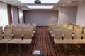 Acoustically satisfactory auditorium with rows of beige chairs