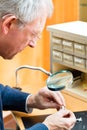 Acoustician working on a hearing aid Royalty Free Stock Photo