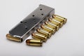 .45 ACP bullets and gun magazine on white background Royalty Free Stock Photo