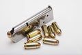 .45 ACP bullets and gun magazine on white background