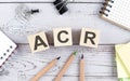 ACR text on wooden block with office tools on the wooden background Royalty Free Stock Photo