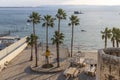 Sunset view of the Horses beach, the sea wall and the fishing port, with locals and visitors, in Royalty Free Stock Photo