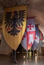 Vintage knightly flags in the hall of the Crusader fortress of the old city of Acre in northern Israel