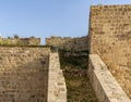 ACRE, ISRAEL - MARCH 23, 2018: Old Acre city walls, Israel. A heavy land defensive wall with cannon outposts.