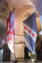 Knightly flags with coats of arms set in halls in the ruins of the fortress in the old city of Acre in Israel