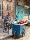 The seller of freshly squeezed juices sits and smokes nargila in anticipation of buyers on the market in the old city of Acre in I