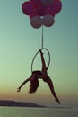 Acrobat girl doing acrobatic tricks. Royalty Free Stock Photo