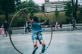 Acrobat on a hula hoop does tricks at Buskers Festival