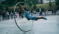 Acrobat on a hula hoop does tricks at Buskers Festival